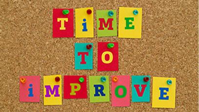 Colored tiles spelling TIME TO IMPROVE