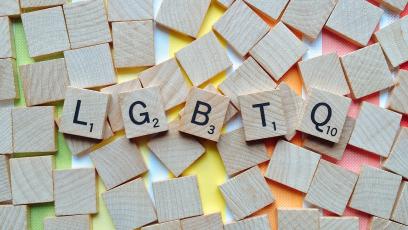 Scrabble tiles that spell out LGBTQ+