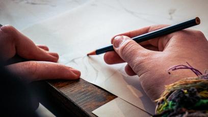 Hands drawing on a notebook