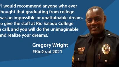 Gregory Wright in uniform smiling at camera in front of blue waves background.