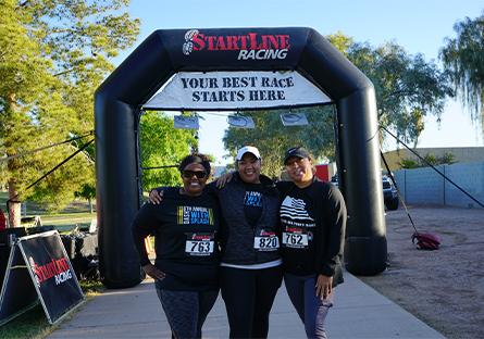 trio of runners posing at the starting line