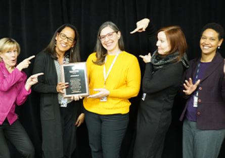 President Kate with Community Development directors and managers holding a plague