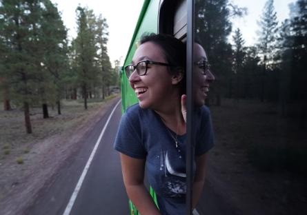 photo of Mariah Schneider looking out the window of a RV