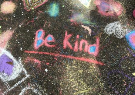 Be Kind written in chalk on the sidewalk